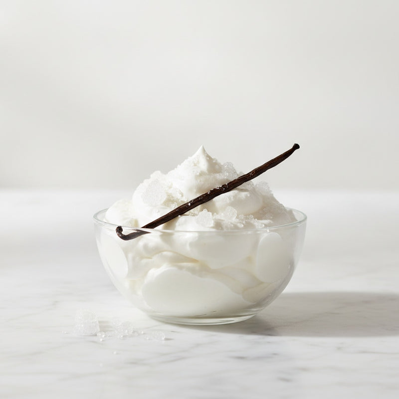 Meringue — Whipped egg whites with vanilla pod and crystallized sugar on marble.